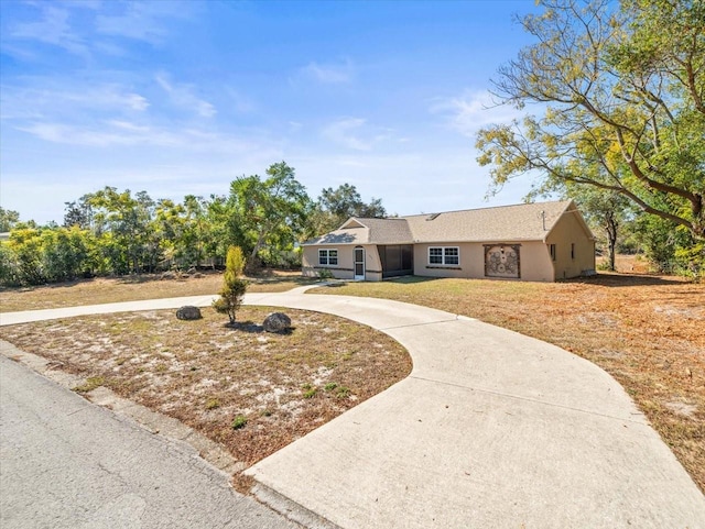 ranch-style home with a front lawn