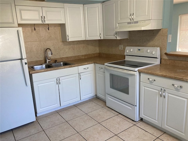 kitchen featuring white appliances, backsplash, sink, light tile patterned flooring, and white cabinetry