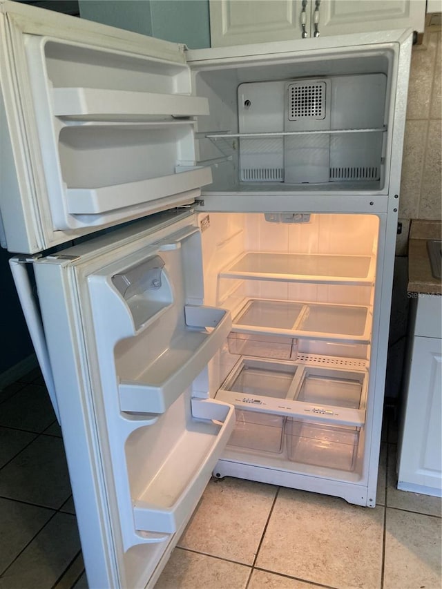 interior details with white cabinets and white refrigerator