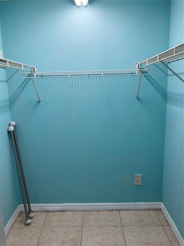 spacious closet featuring light tile patterned flooring