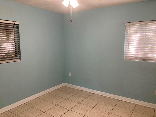 empty room featuring ceiling fan and light tile patterned flooring