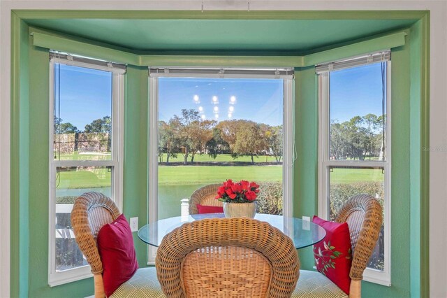 sunroom / solarium with a water view