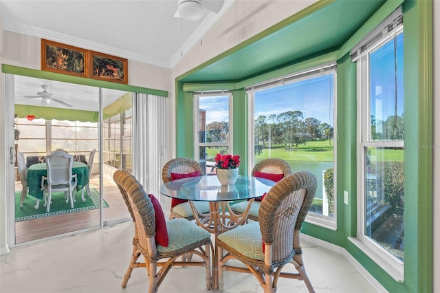 sunroom featuring ceiling fan