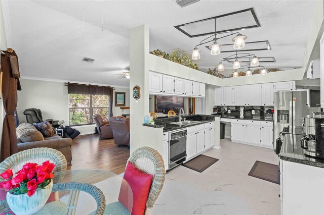 kitchen featuring white cabinetry, sink, black dishwasher, decorative light fixtures, and ceiling fan with notable chandelier