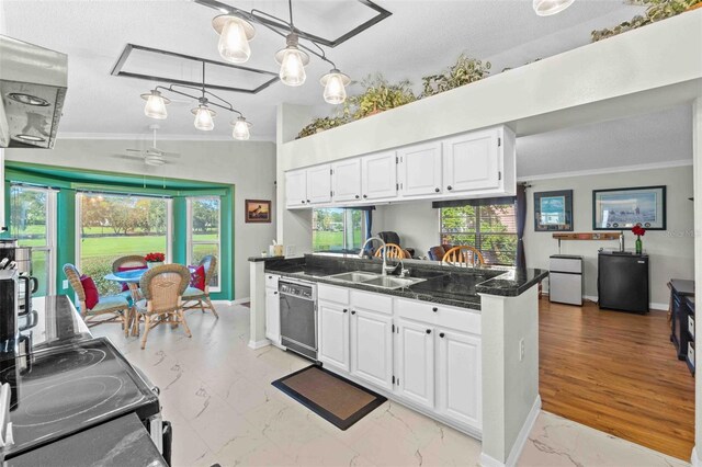 kitchen featuring ceiling fan, sink, decorative light fixtures, dishwasher, and white cabinetry