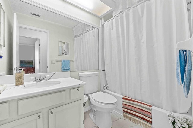 full bathroom featuring vanity, toilet, and shower / tub combo