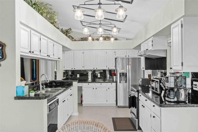 kitchen with pendant lighting, sink, vaulted ceiling, appliances with stainless steel finishes, and white cabinetry