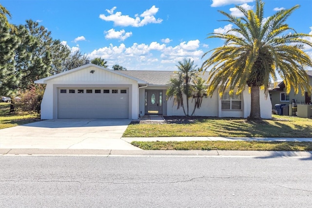 view of front of home with a garage and a front lawn