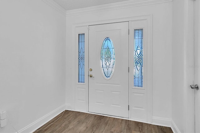 entrance foyer with wood-type flooring and ornamental molding