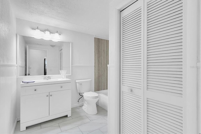 full bathroom featuring a textured ceiling, vanity, toilet, and shower / bathtub combination