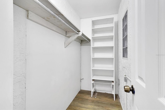 walk in closet featuring dark wood-type flooring