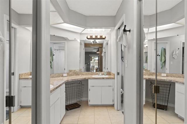 bathroom with tile patterned flooring, ceiling fan, and vanity