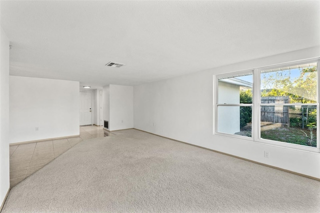 empty room featuring light carpet