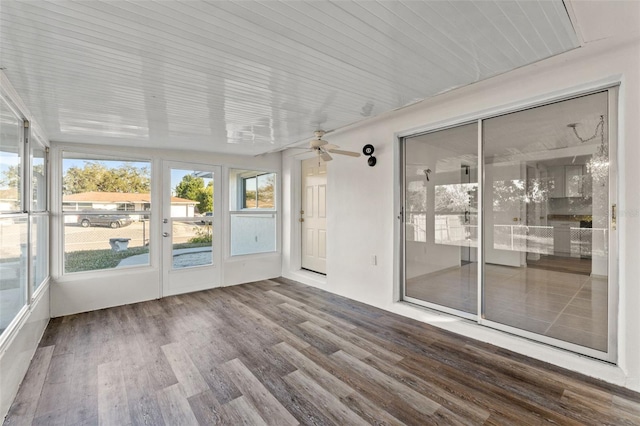 unfurnished sunroom with ceiling fan