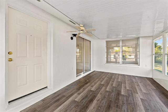 unfurnished sunroom featuring ceiling fan