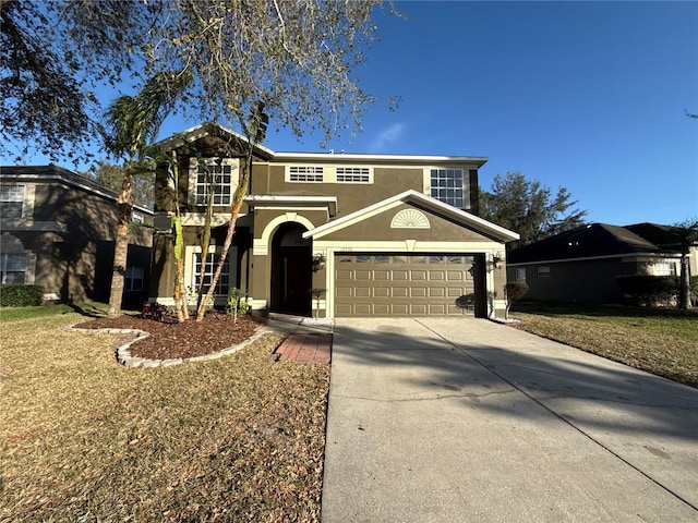 traditional-style house with a front yard, driveway, an attached garage, and stucco siding