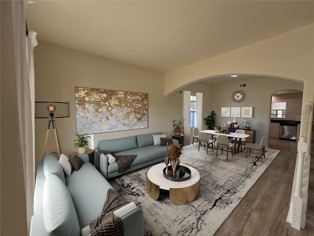 living room with visible vents, arched walkways, and wood finished floors