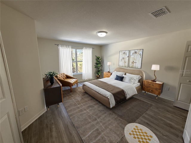 bedroom featuring dark wood-type flooring, visible vents, and baseboards