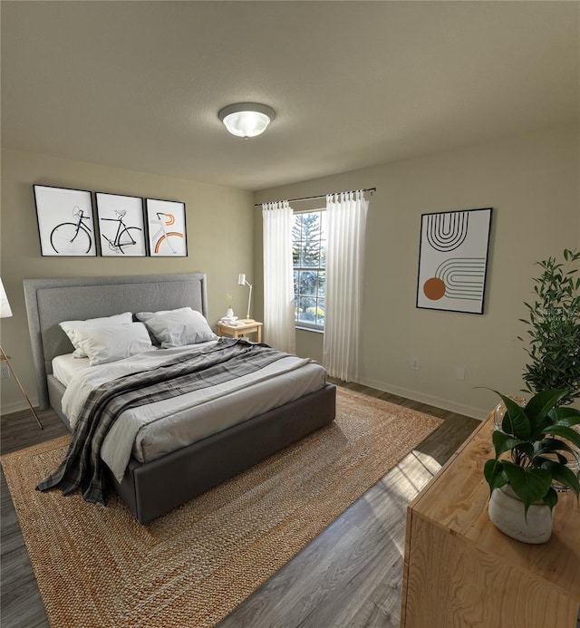 bedroom featuring baseboards and wood finished floors