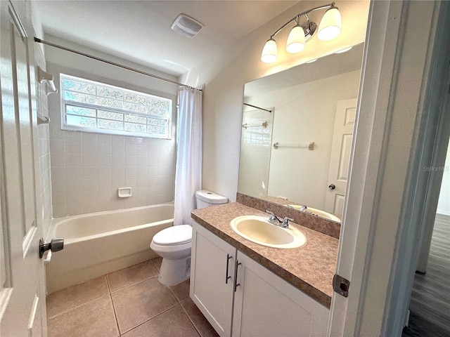 bathroom with visible vents, toilet, tile patterned flooring, shower / bath combo with shower curtain, and vanity