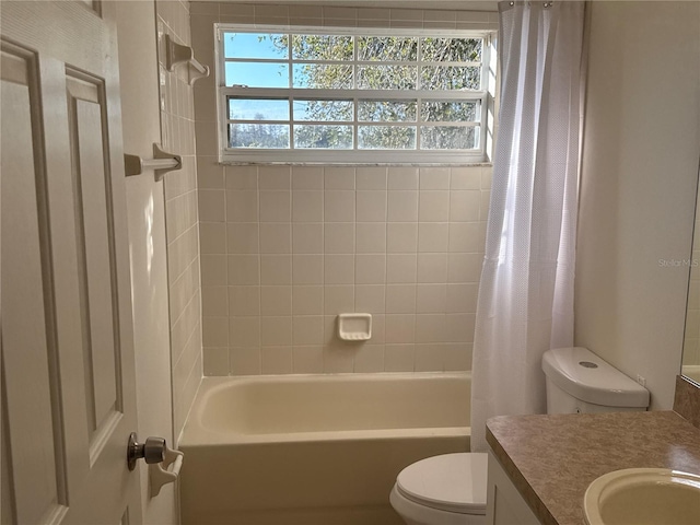 bathroom with shower / bath combo, vanity, and toilet