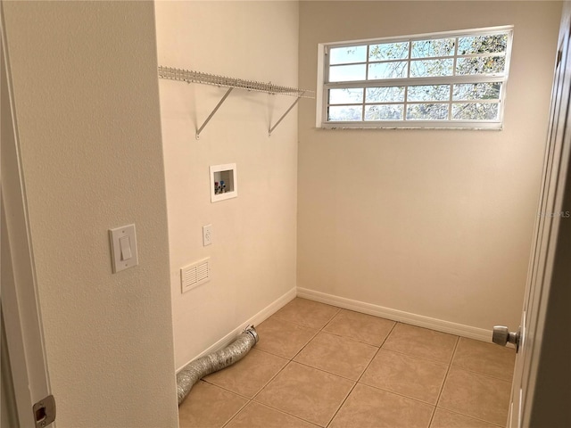 laundry room with laundry area, light tile patterned floors, baseboards, and hookup for a washing machine