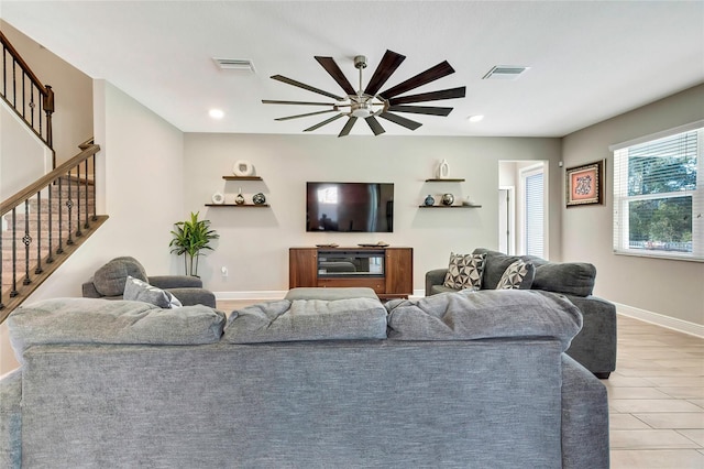 living room featuring ceiling fan and light hardwood / wood-style flooring