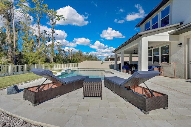 view of swimming pool featuring a patio area, ceiling fan, and outdoor lounge area