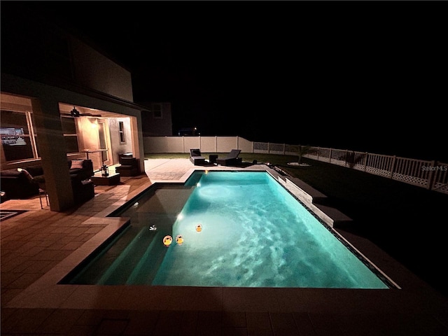 pool at twilight featuring an outdoor living space and a patio