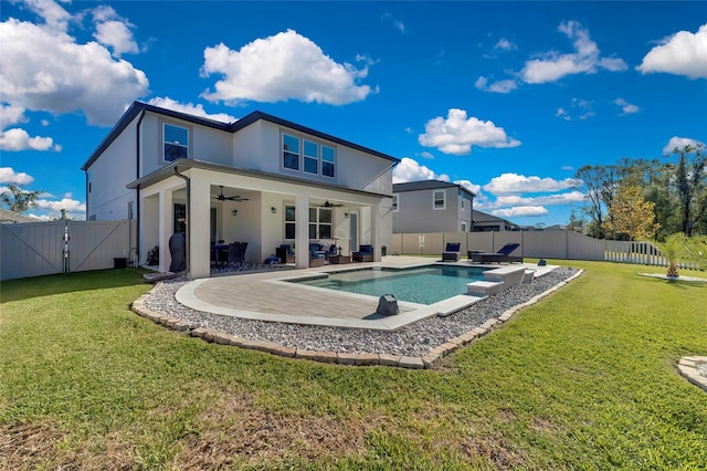 rear view of house with a fenced in pool, ceiling fan, a lawn, and a patio