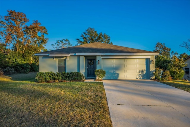 ranch-style house featuring a garage and a front yard