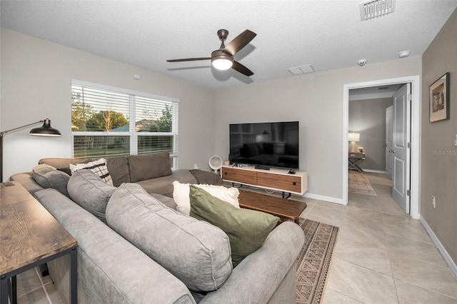 tiled living room with ceiling fan and a textured ceiling