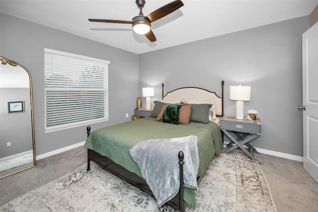 bedroom featuring ceiling fan and light carpet