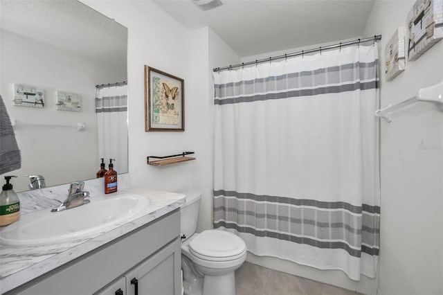 bathroom with toilet, a textured ceiling, vanity, and tile patterned floors