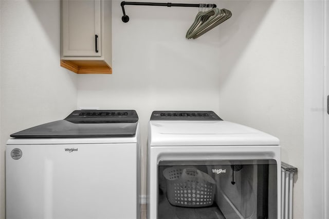 laundry area featuring cabinets and washing machine and dryer