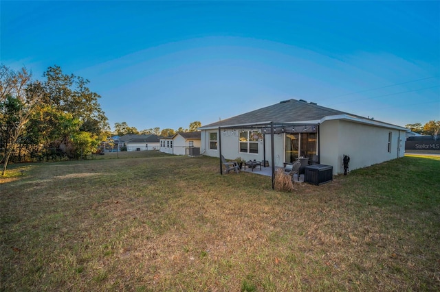 rear view of property with a pergola, cooling unit, a patio area, and a lawn