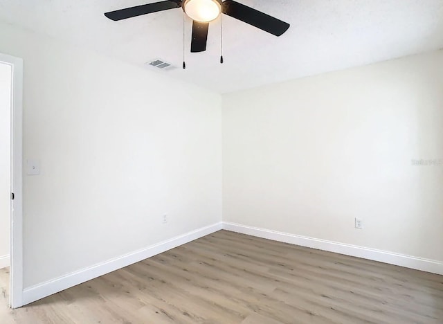 spare room featuring ceiling fan and hardwood / wood-style flooring