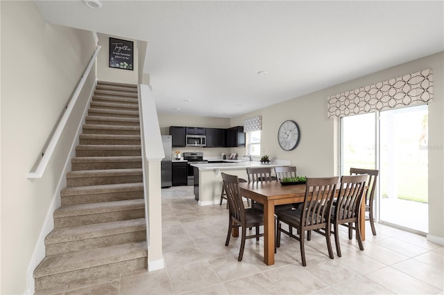 dining space featuring light tile patterned floors