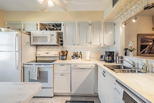 kitchen with backsplash, white appliances, ceiling fan, sink, and white cabinets