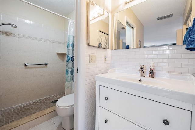 bathroom featuring walk in shower, tile patterned floors, a textured ceiling, and toilet