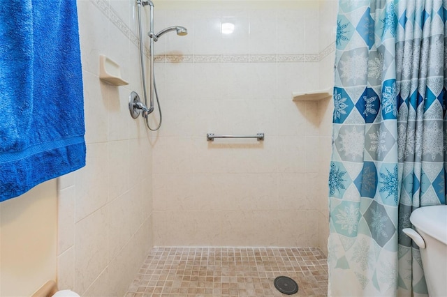 bathroom with a shower with curtain and toilet