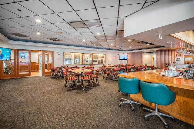 dining space featuring crown molding and carpet floors