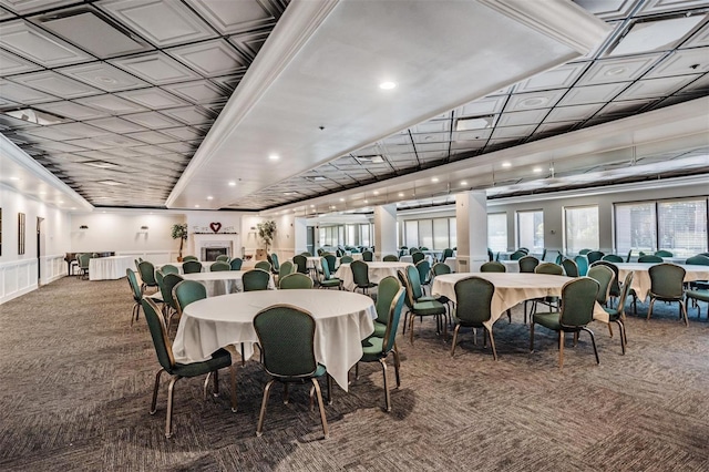 dining space with carpet floors and crown molding