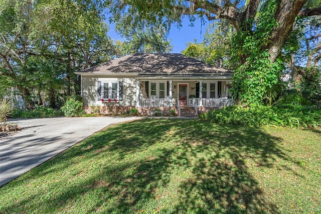 ranch-style home with a porch and a front yard