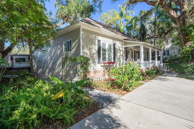 view of side of property with covered porch