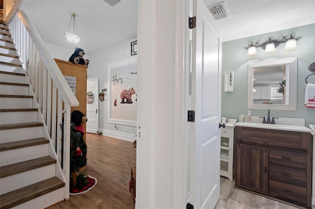 interior space featuring vanity and hardwood / wood-style flooring