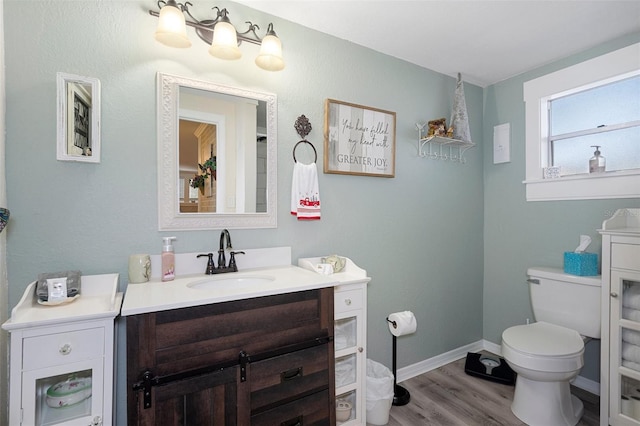 bathroom featuring hardwood / wood-style floors, vanity, and toilet