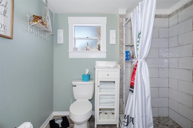 bathroom with walk in shower, ornamental molding, and toilet