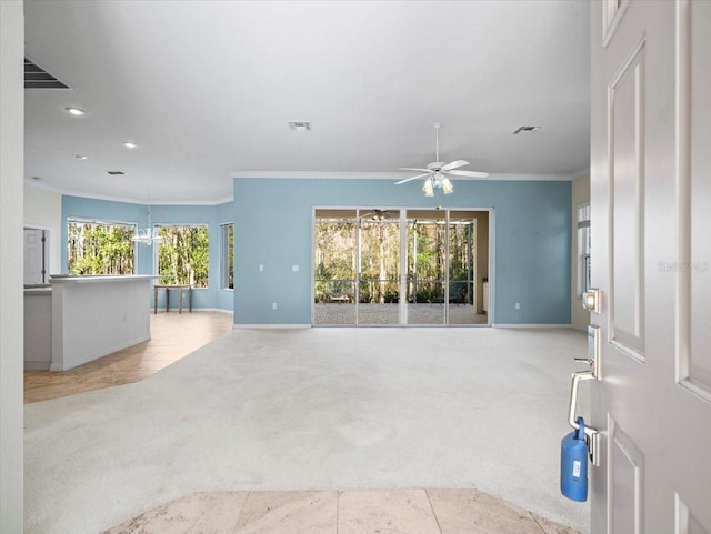 unfurnished living room with light colored carpet, ceiling fan, and crown molding