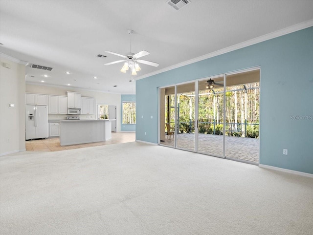 unfurnished living room with ceiling fan, light colored carpet, and ornamental molding